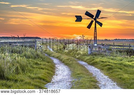 Old American Windmill At Sunset In Dutch Rural Landscape Near Jisp, Noord Holland, Netherlands