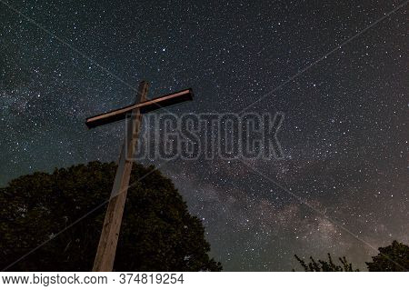 Cross Reaching Clear Spangled Sky At Night