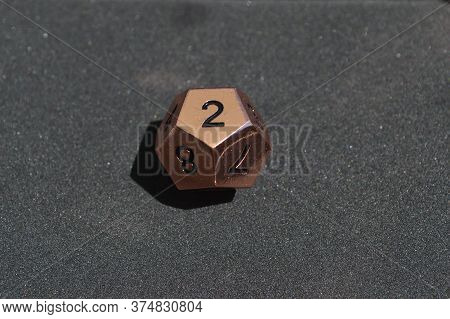 Copper Metallic D12 Twelve Sided Dice On Foam Surface