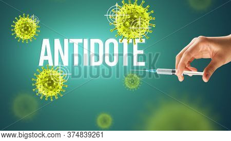Close-up view of doctor's hand in a white glove holding syringe with ANTIDOTE inscription, coronavirus antidote concept