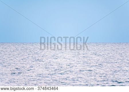 Background Of Sky And Sea, Sea Is Very Calm With Gentle Ripples, Sky Perfectly Clear. Calm Sea And B