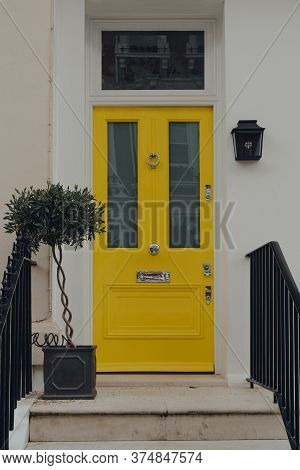 London, Uk - June 20, 2020: Yellow Front Door Of A Traditional House In Kensington And Chelsea, An A