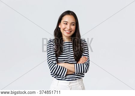 Lifestyle, Beauty And Fashion, People Emotions Concept. Cheerful Cute And Shy Asian Girl Cross Arms 