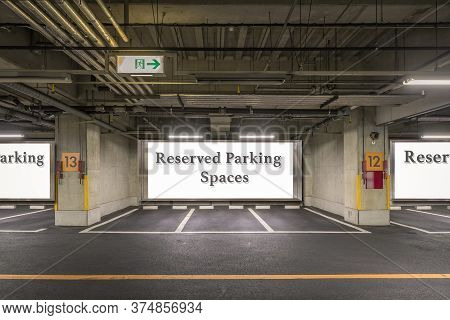 Parking Garage Underground Interior With Reserved Parking Apaces Sign Board