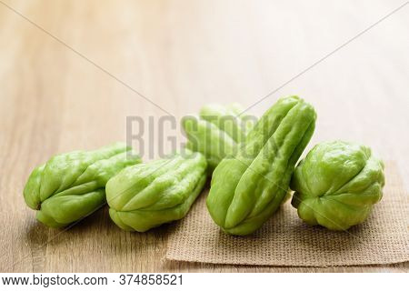 Chayote Squash Or Mirlition Squash On Wooden Background, Organic Vegetable, Edible Plant Fruit