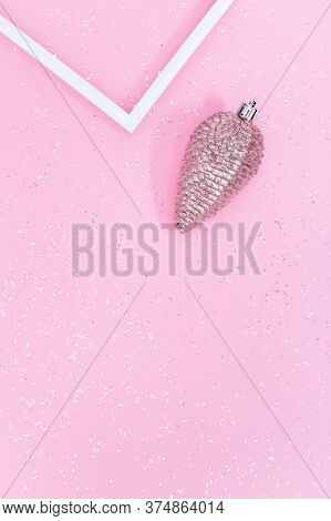 Minimal New Year And Christmas Concept. Pastel Pink Colored Cone Toy On Pink Paper Background Covere