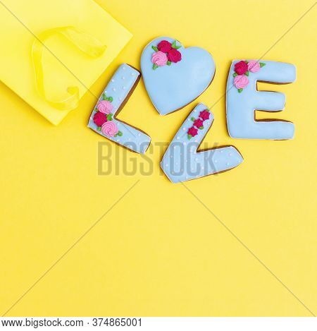 Gingerbread Heart, Cookies In Shape Of Letter Love With Icing On Pastel Yellow Background. Valentine