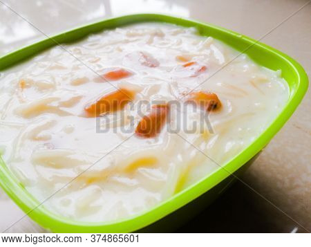 Semiya Milk Payasam Made At Home Is Placed On A Table In A Green Bowl.the Dry Grapes Used In It Is V