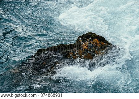 Mossy Stone In Azure Water Of Mountain River Close-up. Blue Nature Background With Boulder With Moss