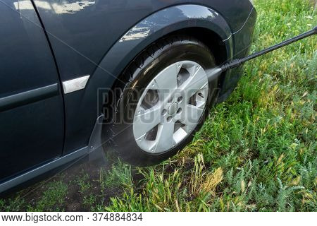 Car Wash, A Woman In Blue Gloves Washes A Car With A Karcher