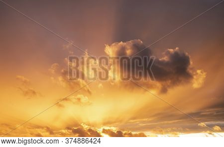 Beautiful Summer Sunset Sky With Colorful Vibrant Clouds And Sun Beams Across Whole Sky