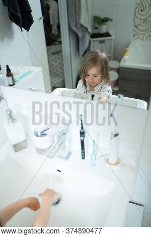 Cute Little Girl 2-3 Years Old Washing Hands With Soap And Water In Bright Bathroom. Adorable Child 