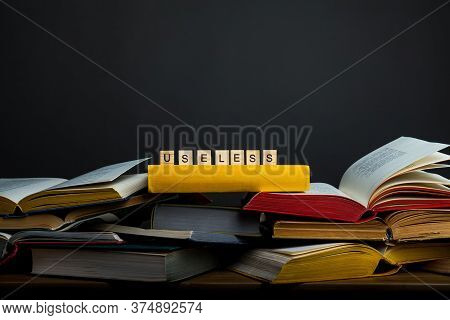 The Concept Of Useless Knowledge. Useless - Word From Wooden Blocks
