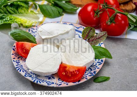 Making Of Fresh Caprese Salad With Soft Italian Cheese From Campania Buffalo Mozzarella With Ripe To