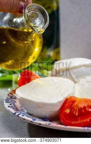 Making Of Fresh Caprese Salad With Soft Italian Cheese From Campania Buffalo Mozzarella With Ripe To