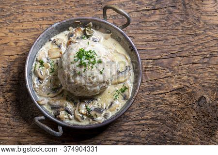 Bavarian Bread Dumpling With Sauce On Dark Wood