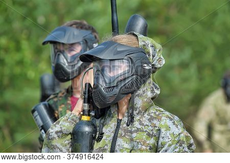 Open-air Paintball Tournament At The End Of Summer In Nature, People In Camouflage, With Paintball G