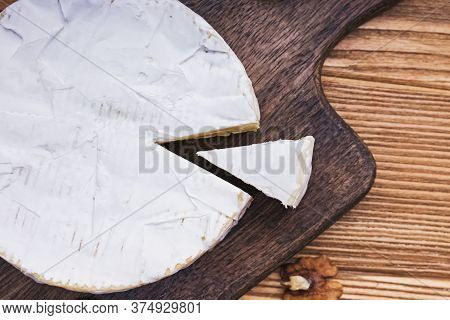 Delicious Soft Camambert Cheese On Wooden Board