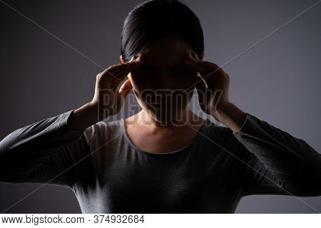 Asian Woman Was Sick With Headache Touching Her Head And Standing Isolated On Background.