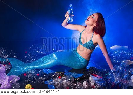 Ocean Plastic Pollution Concept. Mermaid Lives To Polluted Habitat.