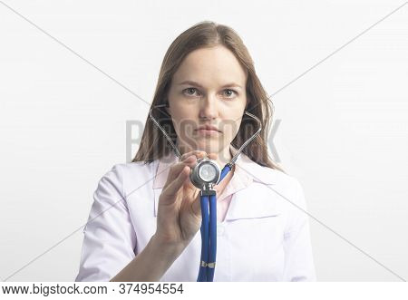 Close Up Portrait Of Young Caucasian Doctor Woman With Stethoscope Using In Direction To Camera In C