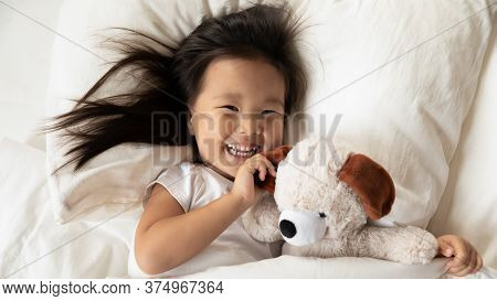 Happy Small Vietnamese Kid Girl Waking Up In Morning.