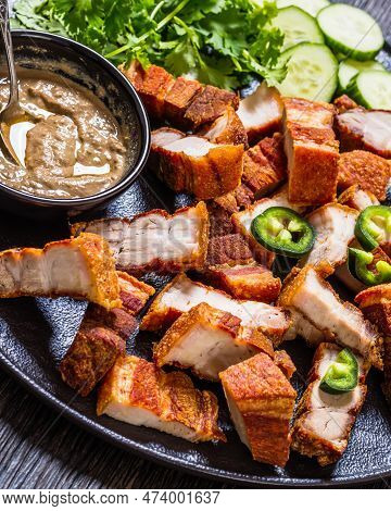 Lechon Kawali, Filipino Crispy Fried Pork Belly With Liver Sauce, Sliced Cucumber And Fresh Coriande