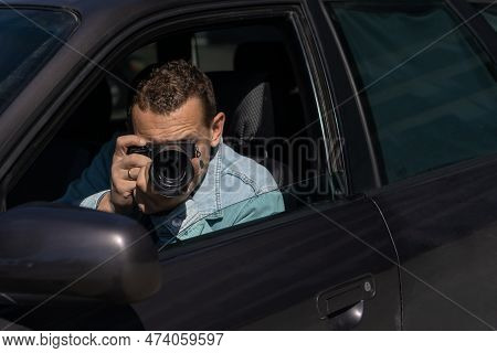 Paparazzi Men Or Guy In Sunglasse Sits In Her Car And Takes Pictures Of Famous Person.spy With Camer