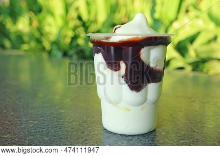Mouthwatering Vanilla Soft Serve Ice Cream With Chocolate Sauce