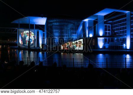 Berlin, Germany-august 8, 2022:people Admire A Memorial Event Made Of Lights And Films Projected On 