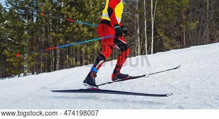 Male Athlete Skier Running Skiing Uphill Cross Country Skiing Side View, Winter Sports Competition