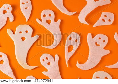 White Ghosts Kids Craft For Halloween. Wrapping Paper Ghost On Orange Background Top View. A Scary A