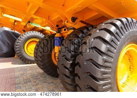 Huge Rear Wheels Of Dump Truck At Unusual Angle Closeup.