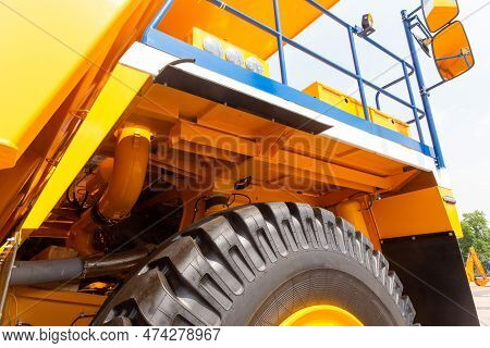 Huge Rear Wheels Of Dump Truck At Unusual Angle Closeup.