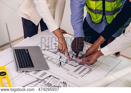 Team Engineers With Draft Plan Of Building On Constructing Site. Engineer Work On Site. Engineer Vis
