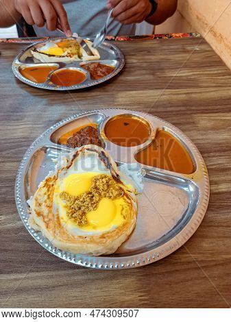 Special Roti Sarang Burung With Redang Gravy On The Eggs. It Is Pratha Looks Like Bird Nest With Hal