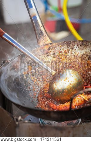 Cooking Fried Kue Teow Noodles In A Wok At A Local Stall In Asia.