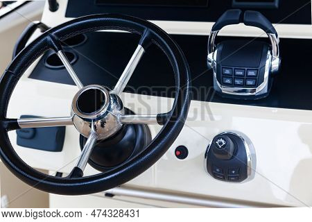 Luxury Yacht Control Panel With Steering Wheel, Gear Levers, Navigation Devices And Control Buttons.
