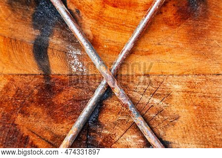 Two Wooden Beams Fastened With Steel Bars Cross To Cross, Close-up.