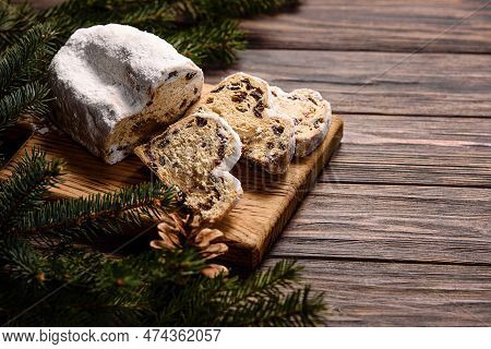 Christmas Stollen On Wooden Background. Traditional Christmas German Dessert Cut Into Pieces. Cake W