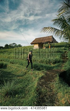 Jatiluwih, Indonesia - November 3, 2021 : A Woman Walking At Rice Field In Jatiluwih, Bali, Indonesi