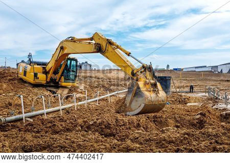 Excavator Dig The Trenches At A Construction Site. Trench For Laying External Sewer Pipes. Sewage Dr