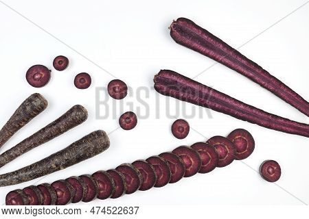 Fancy Colorful Vegetables. Set Of Purple Carrots On Light Background. Copy Space.