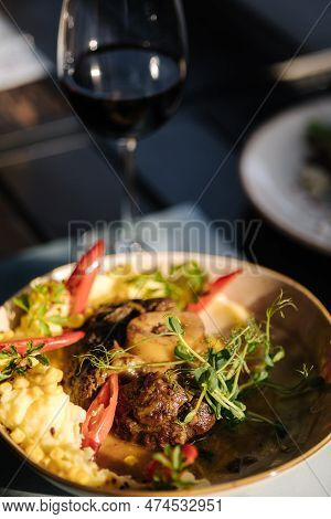 Roasted Succulent Pork Fore Shank With Vegetables. Knuckle With Glass Of Red Wine
