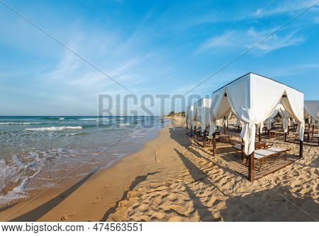 Beach Tents Canopies On Morning Paradise White Sandy Sea Beach, Apulia, Italy.