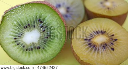 Sliced Kiwis On A Yellow Cutting Board. The Yellow One Is Called Actinidia Chinensis Or Golden Kiwif