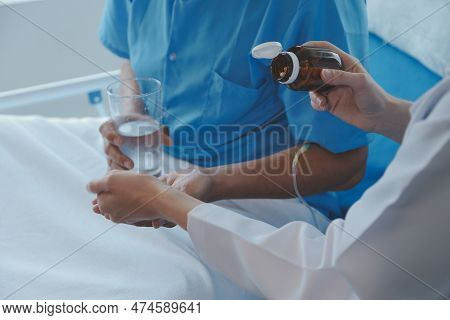Injured Patient Showing Doctor Broken Wrist And Arm With Bandage In Hospital Office Or Emergency Roo