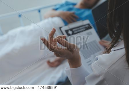 Injured Patient Showing Doctor Broken Wrist And Arm With Bandage In Hospital Office Or Emergency Roo