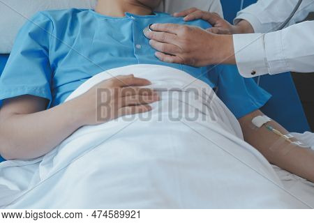 Injured Patient Showing Doctor Broken Wrist And Arm With Bandage In Hospital Office Or Emergency Roo