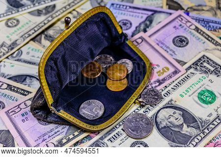 Old Wallet With American Cent Coins Over Dollar Banknotes